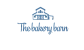 A bakery logo on a white background featuring a blue line-art barn illustration above the words 'The bakery barn' in blue script, with the tagline 'Baked for the moments that matter' in black cursive below.

